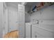 Functional laundry room with a washer, dryer, storage shelves, and a door at 5405 Swordsman Ct, Knightdale, NC 27545