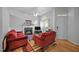 Cozy living room with fireplace, hardwood floors, and natural light from the large window at 5405 Swordsman Ct, Knightdale, NC 27545
