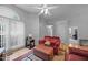 Inviting living room featuring hardwood floors, an area rug, and large sunlit windows at 5405 Swordsman Ct, Knightdale, NC 27545
