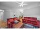 Spacious living area featuring hardwood floors, ceiling fan, and an adjacent dining space at 5405 Swordsman Ct, Knightdale, NC 27545