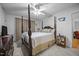 Spacious main bedroom with a four post bed, ceiling fan and ensuite bathroom at 5405 Swordsman Ct, Knightdale, NC 27545
