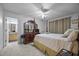 Main bedroom with an ensuite bathroom, four poster bed and ceiling fan at 5405 Swordsman Ct, Knightdale, NC 27545
