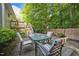 A cozy outdoor patio featuring a dining table and chairs on a stone surface at 5405 Swordsman Ct, Knightdale, NC 27545