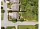 Aerial view of the home showcasing its position on a corner lot with mature trees and a spacious driveway at 5545 Moneta Ln, Apex, NC 27539