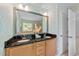 Bathroom with dual sinks, granite countertops, and decorative wallpaper at 5545 Moneta Ln, Apex, NC 27539