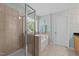 Bathroom showcases a glass shower, soaking tub, and decorative wallpaper at 5545 Moneta Ln, Apex, NC 27539
