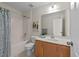 Bright bathroom with shower-tub combo, single vanity, and neutral decor at 5545 Moneta Ln, Apex, NC 27539