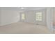 Spacious bedroom featuring neutral walls, carpet, and natural light at 5545 Moneta Ln, Apex, NC 27539