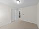 Bedroom featuring neutral carpet, double closets and doorway to bathroom at 5545 Moneta Ln, Apex, NC 27539