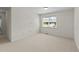 Bedroom with a large window, carpet, and base molding at 5545 Moneta Ln, Apex, NC 27539