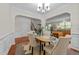 Open dining room with wood floors, modern furniture, and direct access to the kitchen, ideal for Gathering gatherings at 5545 Moneta Ln, Apex, NC 27539