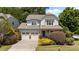 Charming two-story home with a two car garage, inviting front porch, and beautifully landscaped front yard at 5545 Moneta Ln, Apex, NC 27539