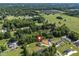 An aerial perspective highlights the property's generous lot and mature trees in a private setting near a serene pond at 567 E Ridge Ave, Liberty, NC 27298