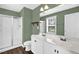 Bathroom featuring a double vanity with white cabinets, a toilet, and a shower with glass door at 567 E Ridge Ave, Liberty, NC 27298