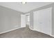 This bedroom features neutral carpet, walls, and trim, along with double closets and a view to another room at 567 E Ridge Ave, Liberty, NC 27298