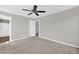 Bedroom featuring carpet floors, ceiling fan, a doorway to the en suite bathroom, and a door to the walk-in closet at 567 E Ridge Ave, Liberty, NC 27298