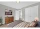 Bedroom features include an art piece, wooden dresser, plush carpet, and a view into another room at 567 E Ridge Ave, Liberty, NC 27298