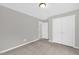 Bedroom featuring carpet floors, a ceiling light, and a door to the closet with double doors at 567 E Ridge Ave, Liberty, NC 27298