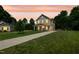 Charming two-story home with covered porch and long driveway on a spacious lawn at 567 E Ridge Ave, Liberty, NC 27298