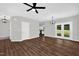 Spacious living area with hardwood floors and French doors leading to the outside at 567 E Ridge Ave, Liberty, NC 27298