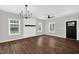 Bright living room with hardwood floors and a modern chandelier at 567 E Ridge Ave, Liberty, NC 27298