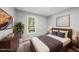 Stylishly staged bedroom featuring modern furniture, decor, and a bright window with backyard views at 6009 Shadow Moss Cir, Raleigh, NC 27603