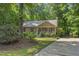 Charming single-Gathering home with a well-maintained lawn and mature trees providing shade at 6009 Shadow Moss Cir, Raleigh, NC 27603