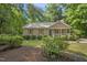 Charming single-story home featuring a cozy front porch and surrounded by mature trees at 6009 Shadow Moss Cir, Raleigh, NC 27603