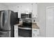 Modern kitchen featuring stainless steel appliances and white cabinetry at 6009 Shadow Moss Cir, Raleigh, NC 27603