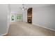 Spacious living room with vaulted ceiling, stone fireplace, and access to the deck at 6009 Shadow Moss Cir, Raleigh, NC 27603