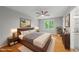 Serene main bedroom showcasing a large bed, natural light, and stylish furnishings at 6009 Shadow Moss Cir, Raleigh, NC 27603