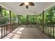 A screened-in porch featuring a ceiling fan and wooden flooring with a view of a wooded area at 6009 Shadow Moss Cir, Raleigh, NC 27603