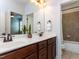 Bathroom featuring a double sink vanity and access to a tiled shower/tub combo at 612 Peach Orchard Pl, Cary, NC 27519