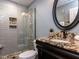 Bathroom featuring a granite-topped vanity, tiled shower, and mosaic accents at 612 Peach Orchard Pl, Cary, NC 27519