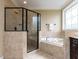 This bathroom features a glass enclosed shower and soaking tub at 612 Peach Orchard Pl, Cary, NC 27519