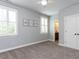 Bedroom featuring carpet, white shutters, and colorful wall decorations at 612 Peach Orchard Pl, Cary, NC 27519