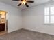 Carpeted bedroom with wainscoting, a ceiling fan, and a window with shutters at 612 Peach Orchard Pl, Cary, NC 27519