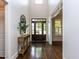 Inviting foyer with hardwood floors, a dark wood front door, and elegant decorative accents at 612 Peach Orchard Pl, Cary, NC 27519
