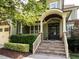 Charming front porch with stone steps, elegant columns, and a decorative wood front door at 612 Peach Orchard Pl, Cary, NC 27519