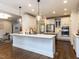 Bright, open kitchen with white cabinetry, an island, stainless steel appliances, and hardwood floors at 612 Peach Orchard Pl, Cary, NC 27519