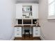 A built in office space with wood desk, white cabinets, drawers, and shelves at 612 Peach Orchard Pl, Cary, NC 27519