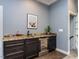 Close up view of a wet bar with granite countertops and a built-in mini fridge at 612 Peach Orchard Pl, Cary, NC 27519