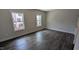 The bedroom offers natural light from two windows and features beautiful hardwood floors at 659 Bandon Aly, Cary, NC 27513