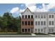 Modern townhome featuring brick and gray siding with black-framed windows at 659 Bandon Aly, Cary, NC 27513