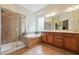 Primary bath includes a double vanity, garden tub, and separate glass shower with neutral tile at 7 Teahouse Ct, Durham, NC 27707