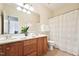 Bathroom with double vanity, mirror, and a shower with a curtain at 7 Teahouse Ct, Durham, NC 27707