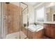 Walk in shower and soaking tub in primary bathroom with neutral tile at 7 Teahouse Ct, Durham, NC 27707