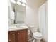 This bright bathroom features a toilet, sink, mirror, vanity, and shower with white shower curtain at 7 Teahouse Ct, Durham, NC 27707