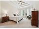 Spacious bedroom with tray ceilings, bright windows, and plush carpet at 7 Teahouse Ct, Durham, NC 27707
