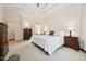 Spacious bedroom with tray ceilings, bright windows, plush carpet, and dark wood furnishings at 7 Teahouse Ct, Durham, NC 27707